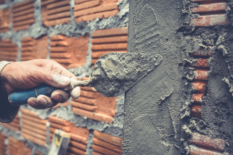 Workers are applying cement with construction additives